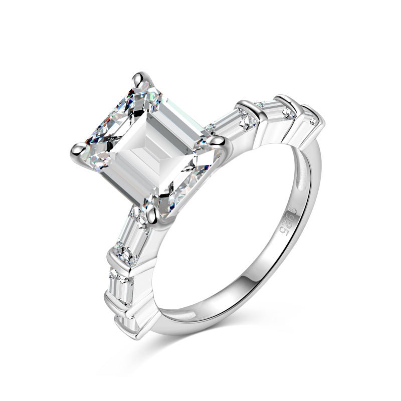 miami emerald ring with baguette side stones on white background