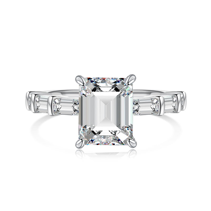 miami emerald ring with baguette side stones on white background