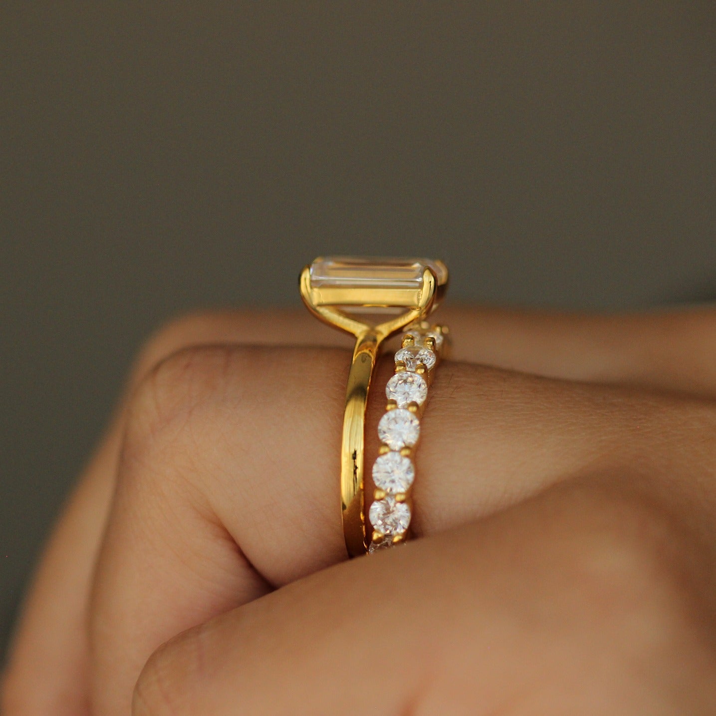 side profile of plain emerald gold vermeil ring on hand with stacking ring