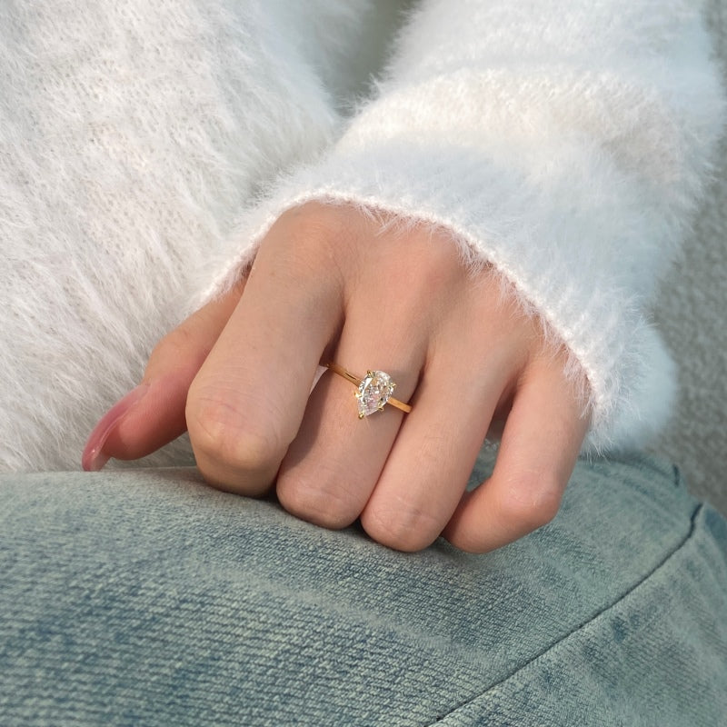 gold pear ring 5 prong setting on hand