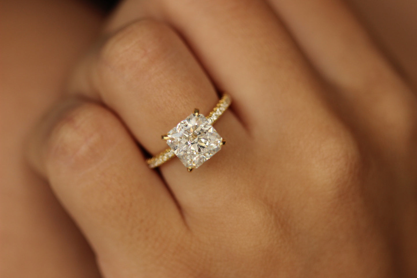 Princess cut gold proposal ring on hand