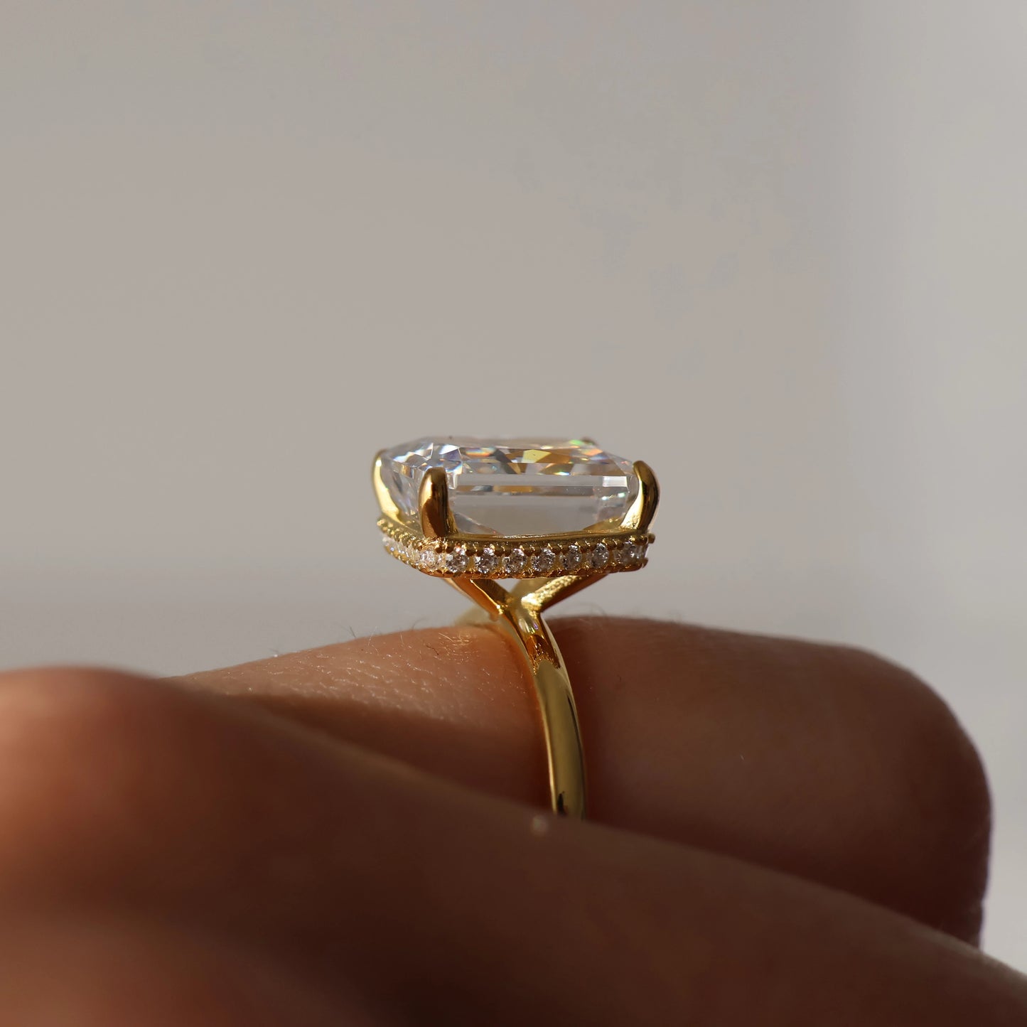radiant cut gold ring with 4 carat centre stone on hand side profile