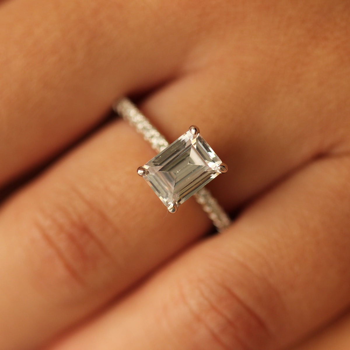 seoul 2 carat emerald cut silver ring on hand