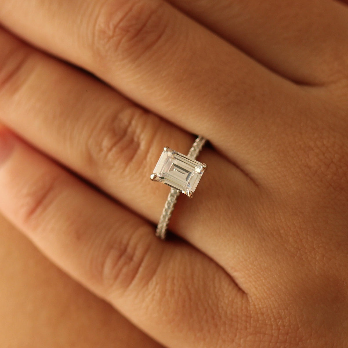 seoul emerald cut ring on hand