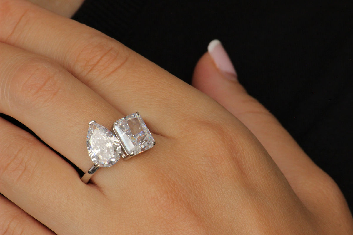 silver toi et moi ring with pear and rectangle stone