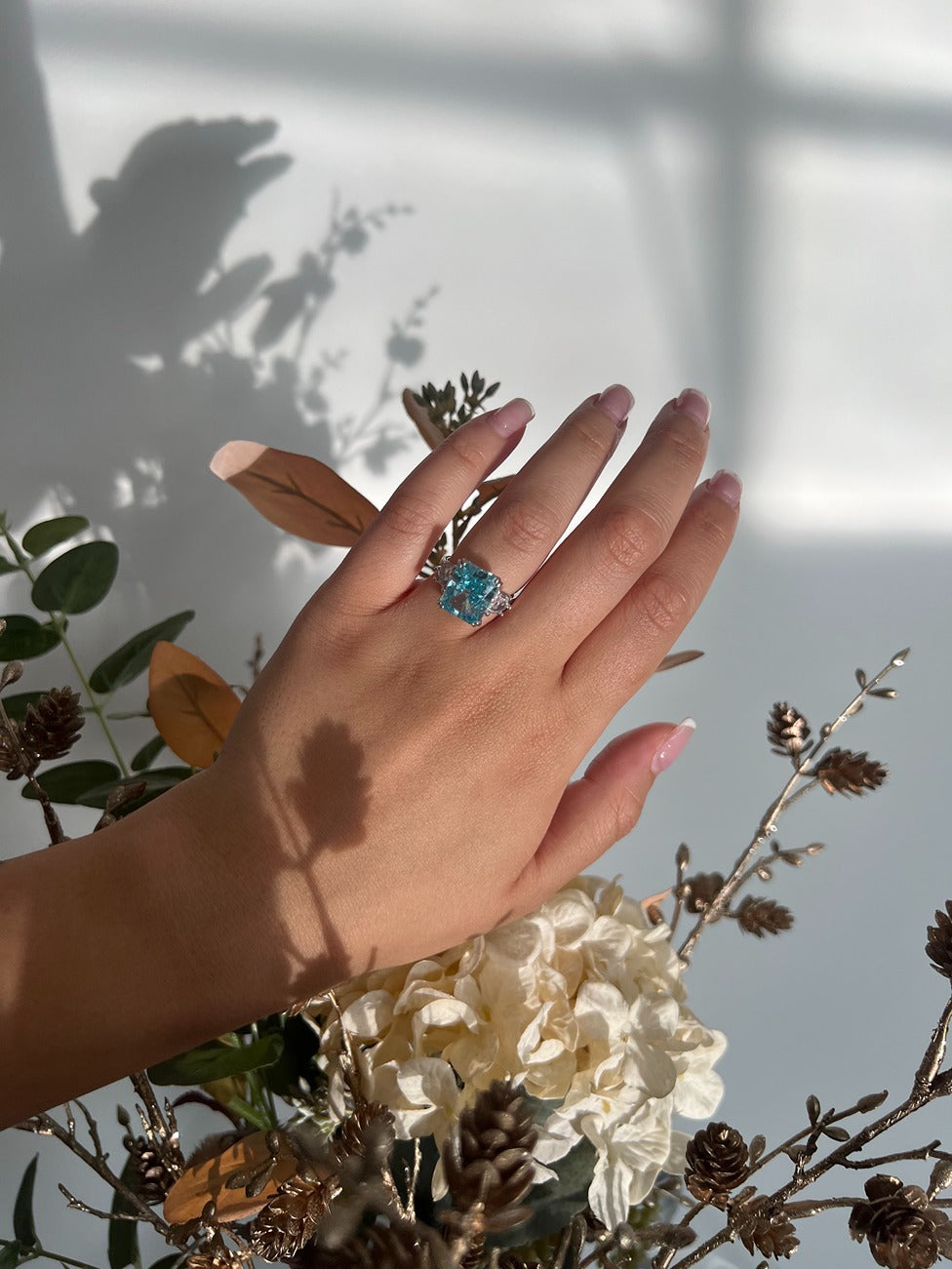 silver rectangle ring with blue cubic zirconia stone