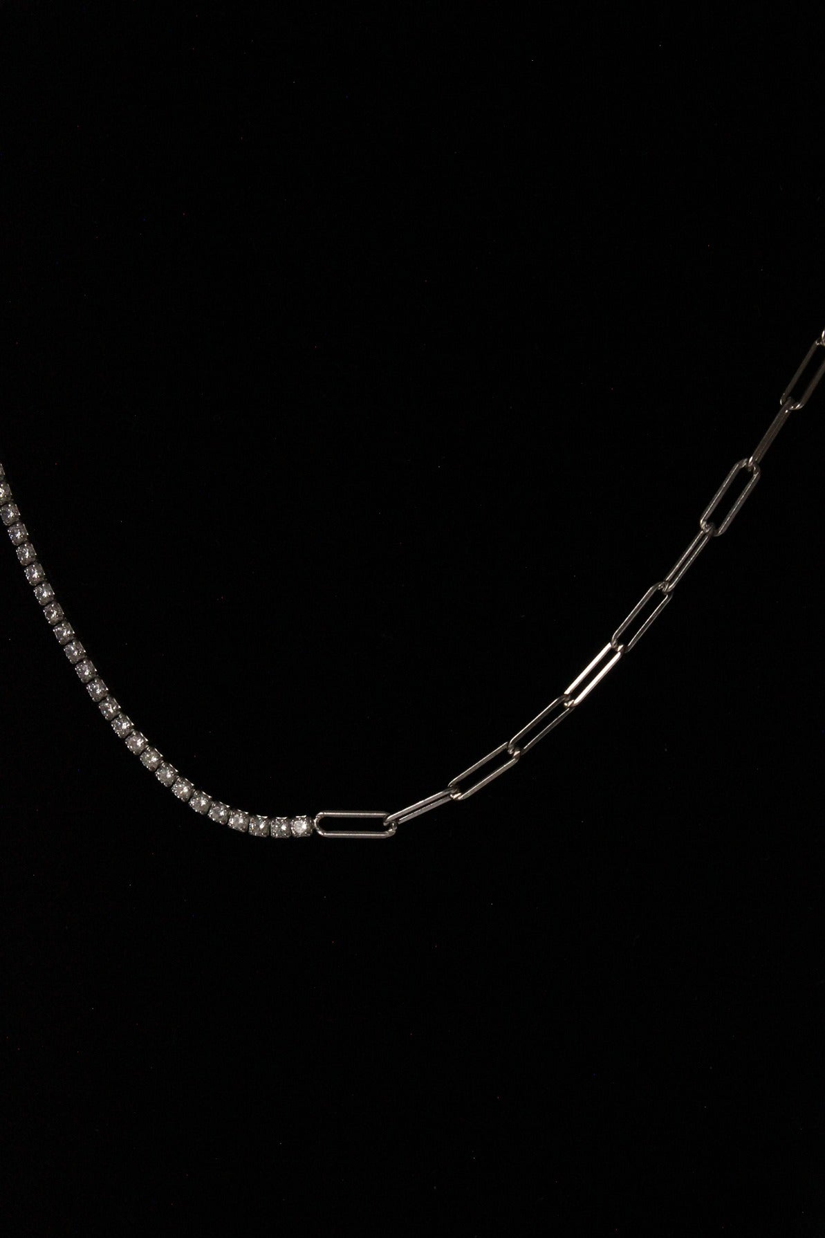 Silver tennis necklace on black mannequin