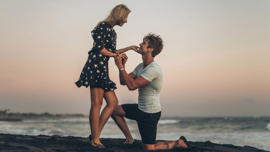 somebody proposing to their partner on the beach