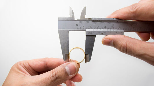 man measuring ring size for girlfriends proposal