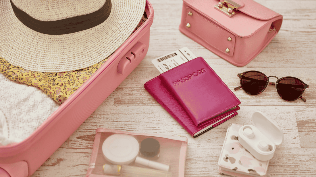 suitcase packed with sunglasses passport and travel jewellery