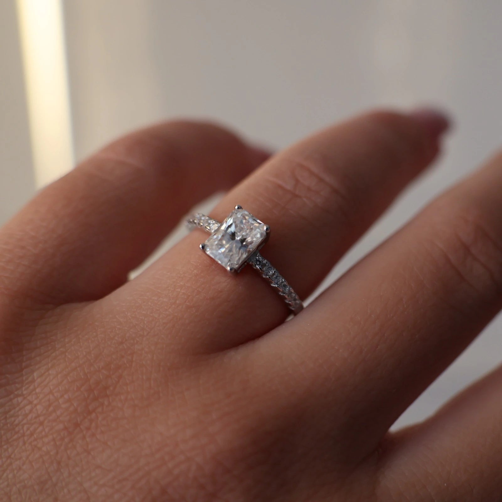 1 carat radiant silver moissanite ring with pavé band