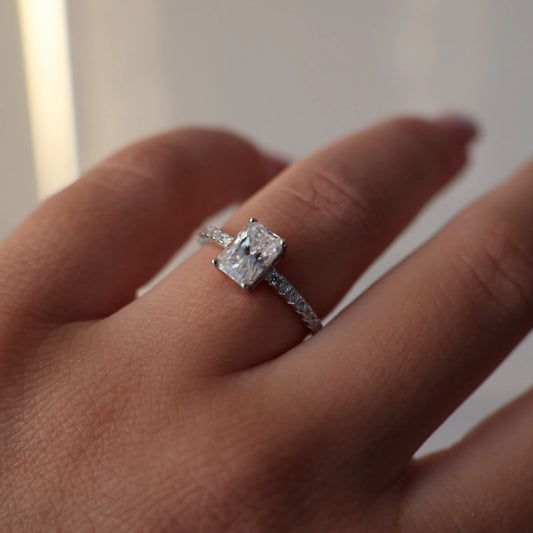 1 carat radiant silver moissanite ring with pavé band