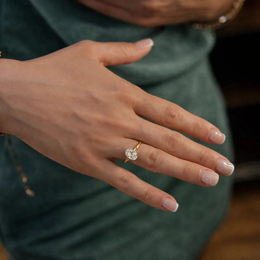 model wearing 1.5 carat gold oval ring with side halo