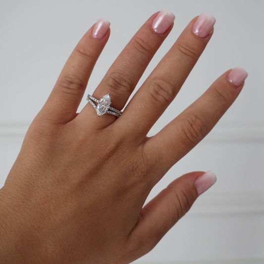 1.5 ct marquise cut cubic zirconia ring stacked with a silver wishbone ring