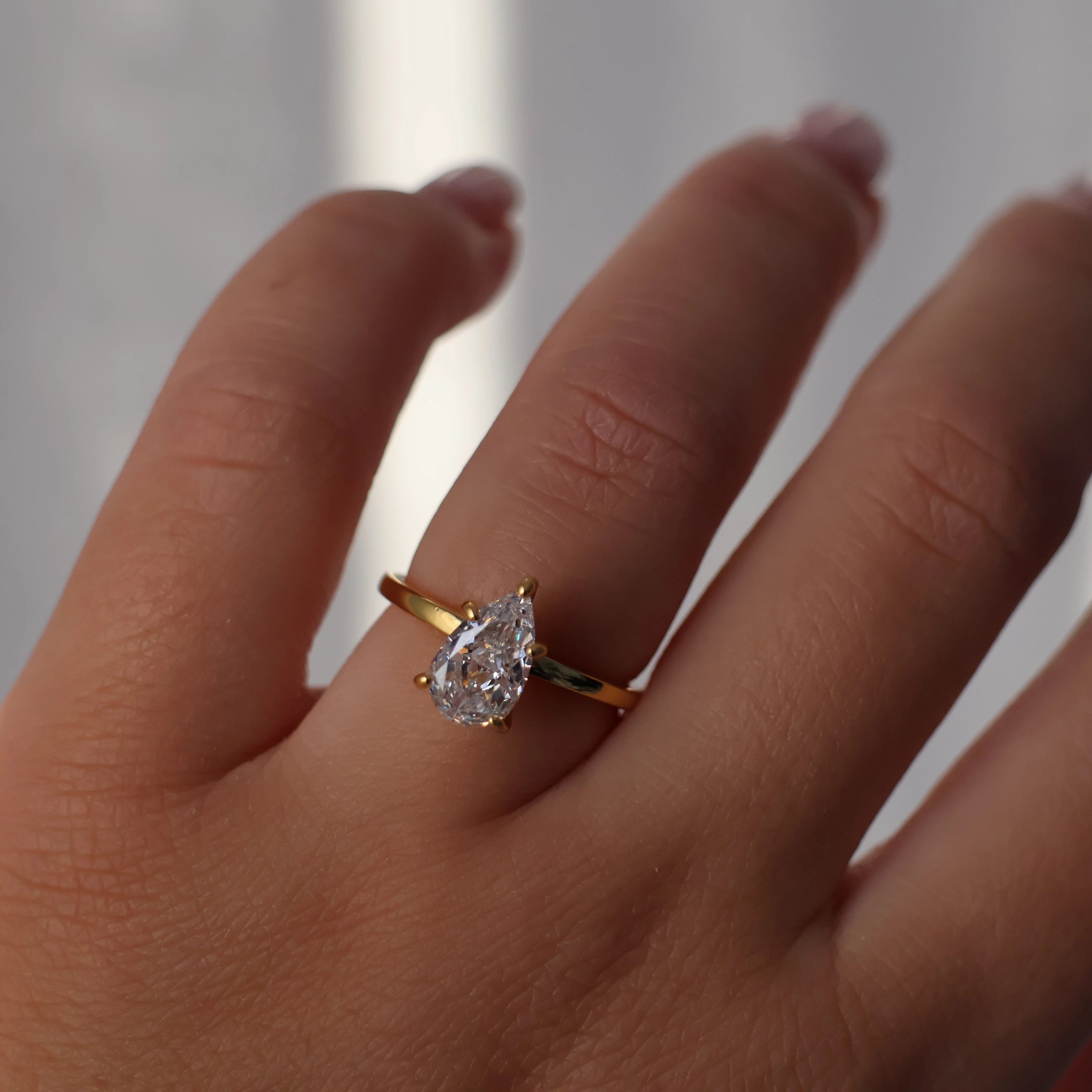 Pear cut 1.75 carat cubic zirconia engagement ring in 18k gold plated finish