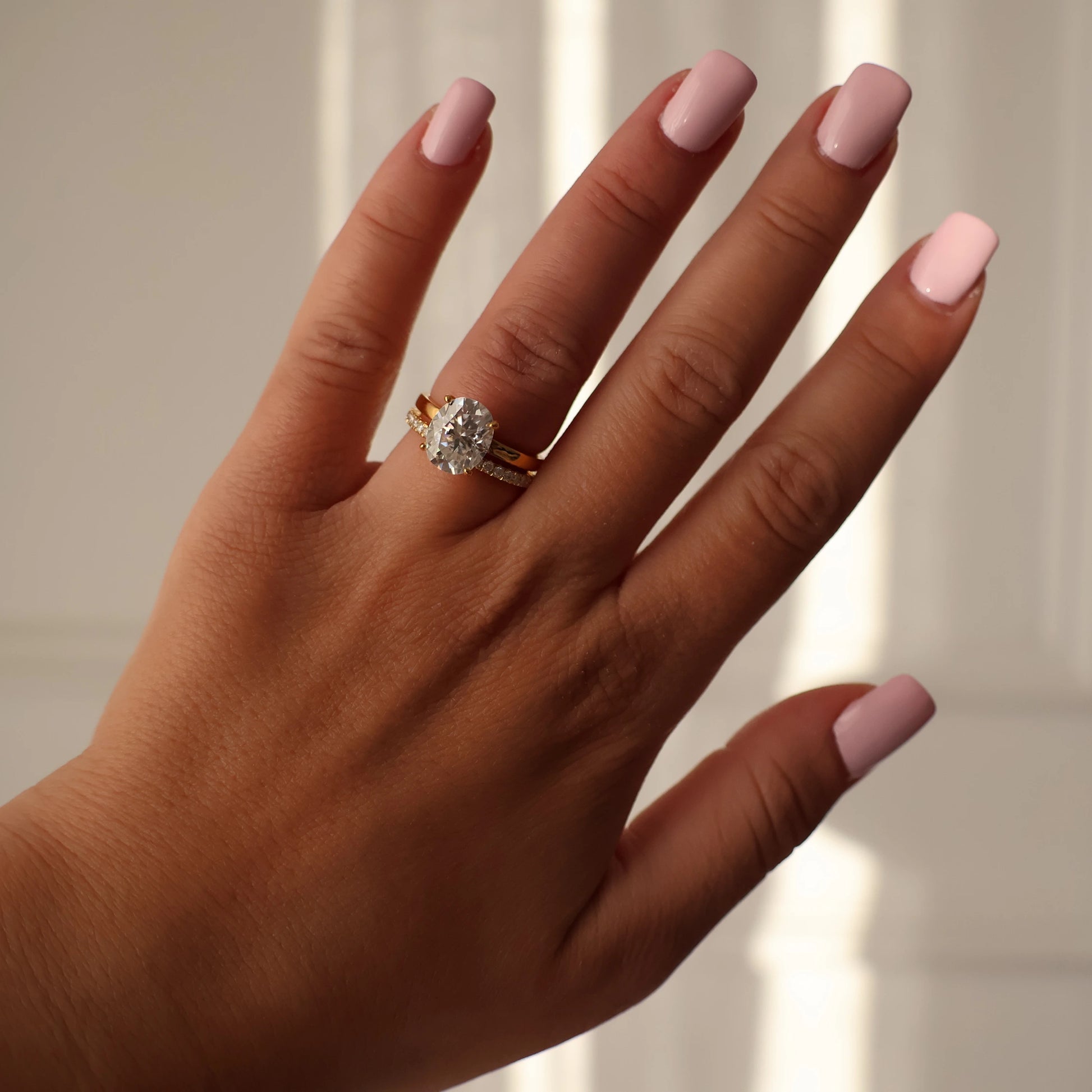2.1mm half eternity moissanite ring stacked with a 3 carat oval moissanite solitaire engagement ring in 14K gold filled