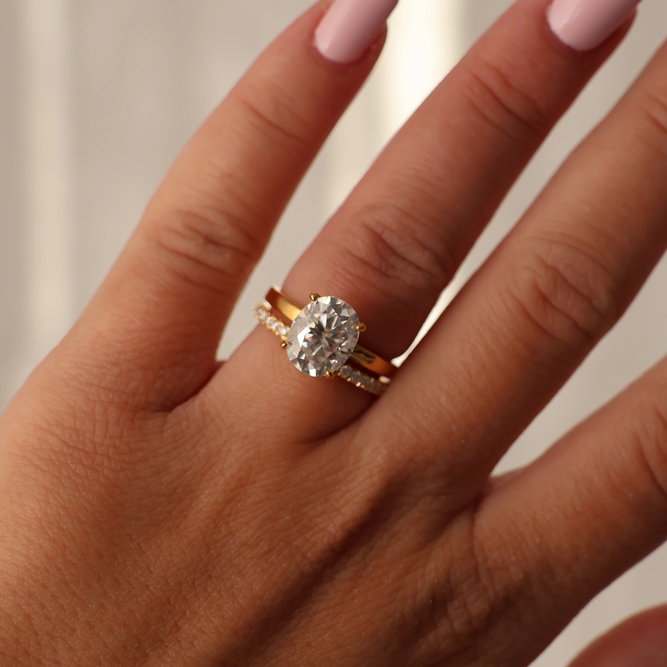 2.1mm half eternity moissanite ring stacked with a 3 carat oval moissanite solitaire engagement ring in 14K gold filled