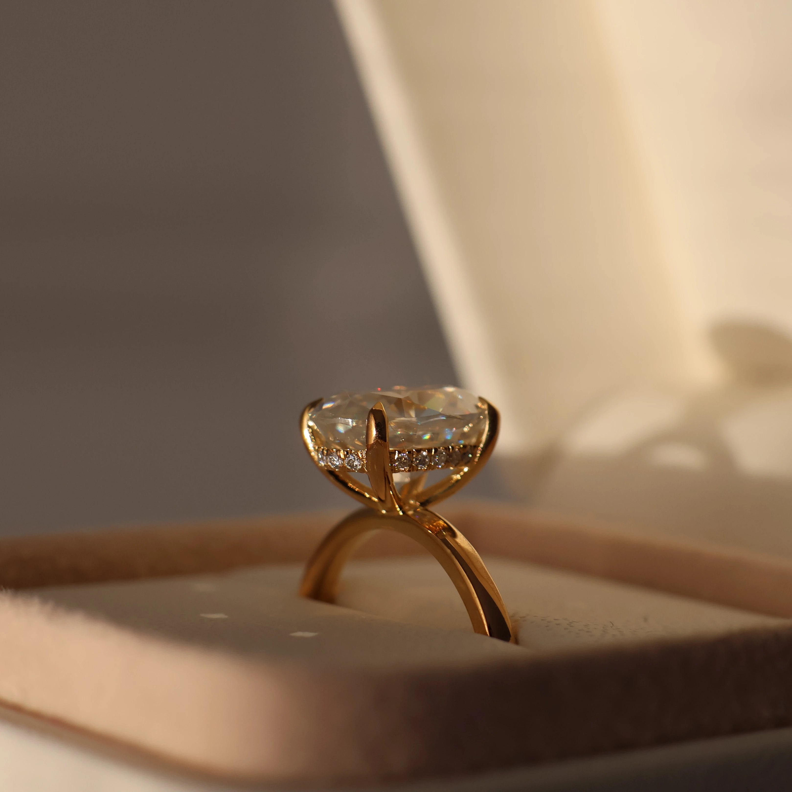 18K gold filled oval moissanite hidden halo ring displayed in a proposal box