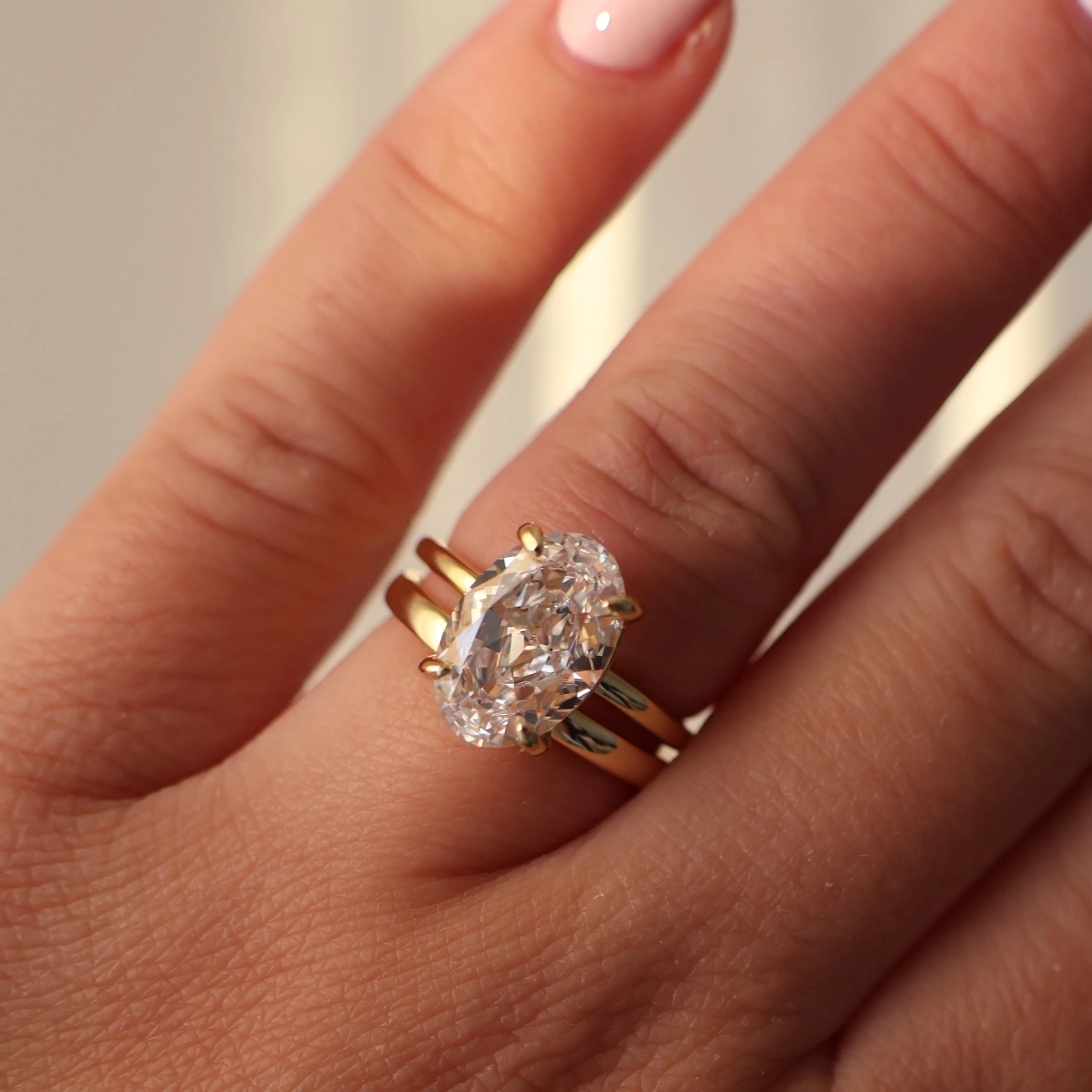 18K gold plated wedding ring stacked with an oval solitaire engagement ring