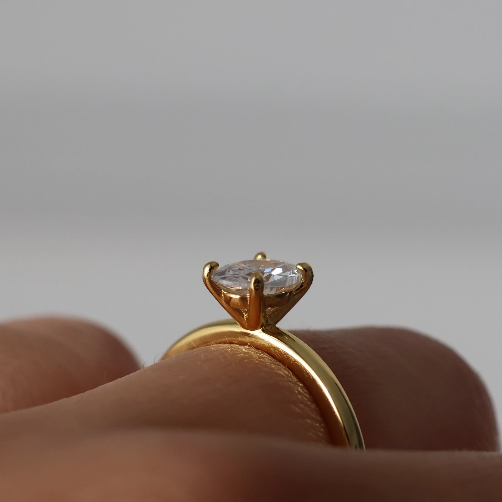 Side view of 1 ct oval solitaire CZ ring in 18k gold plated