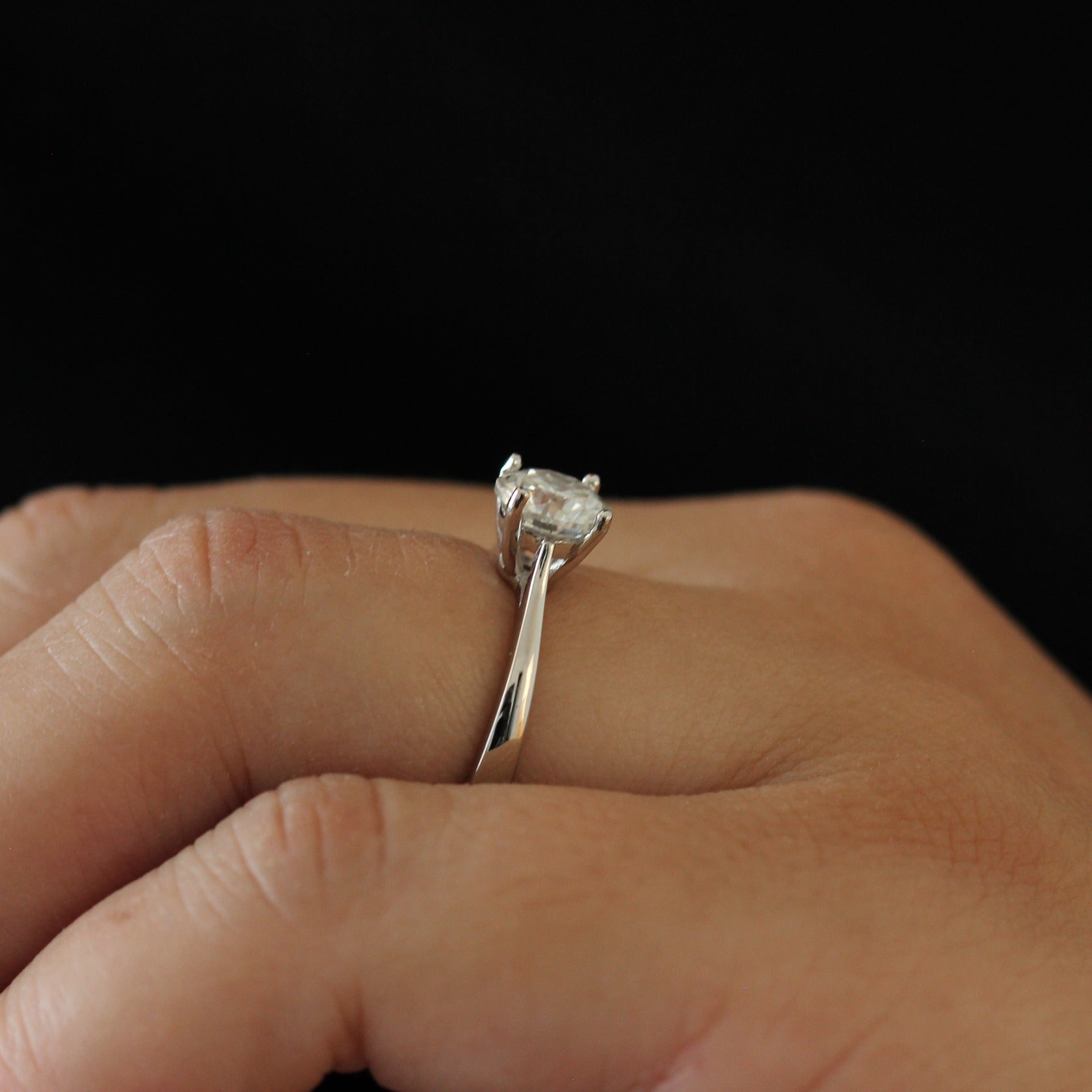Side view of a 1 carat round moissanite solitaire ring