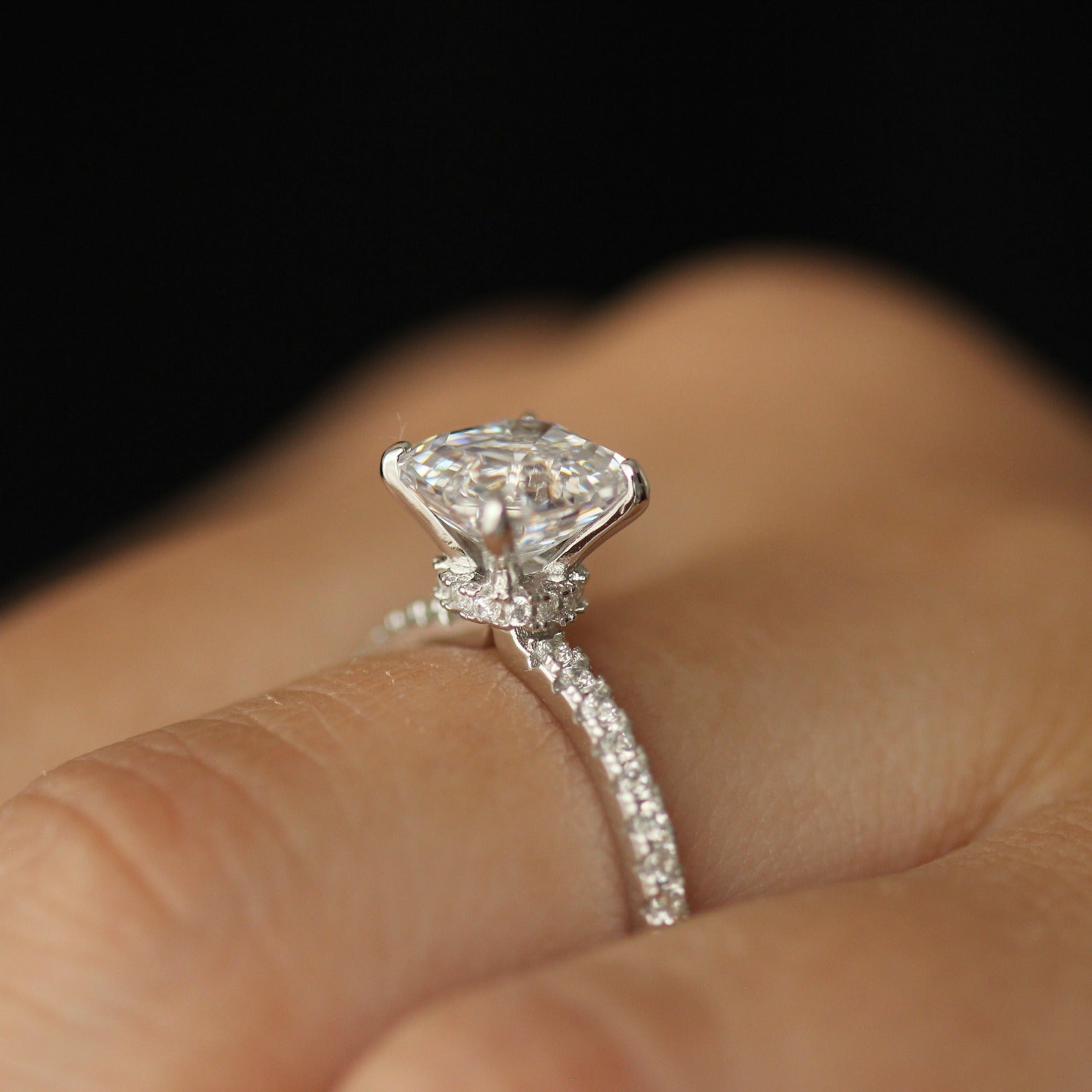side view of cubic zirconia ring with asscher cut centre stone and pave band on hand