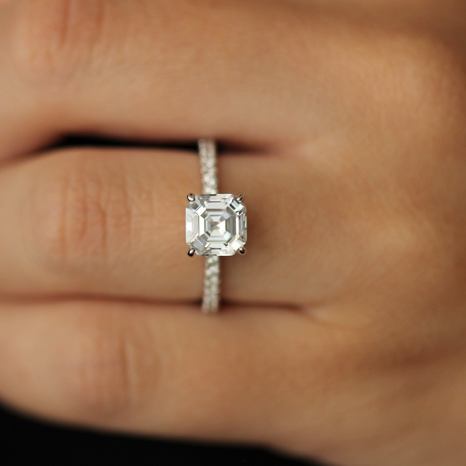 Cubic zirconia ring with 2 carat asscher cut centre stone and pave band on hand