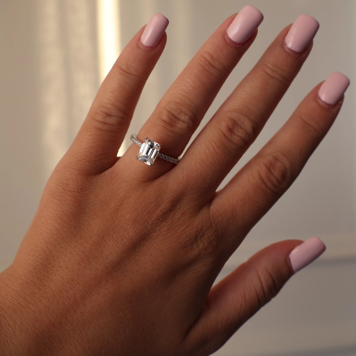 2 carat emerald cut moissanite ring with pave setting
