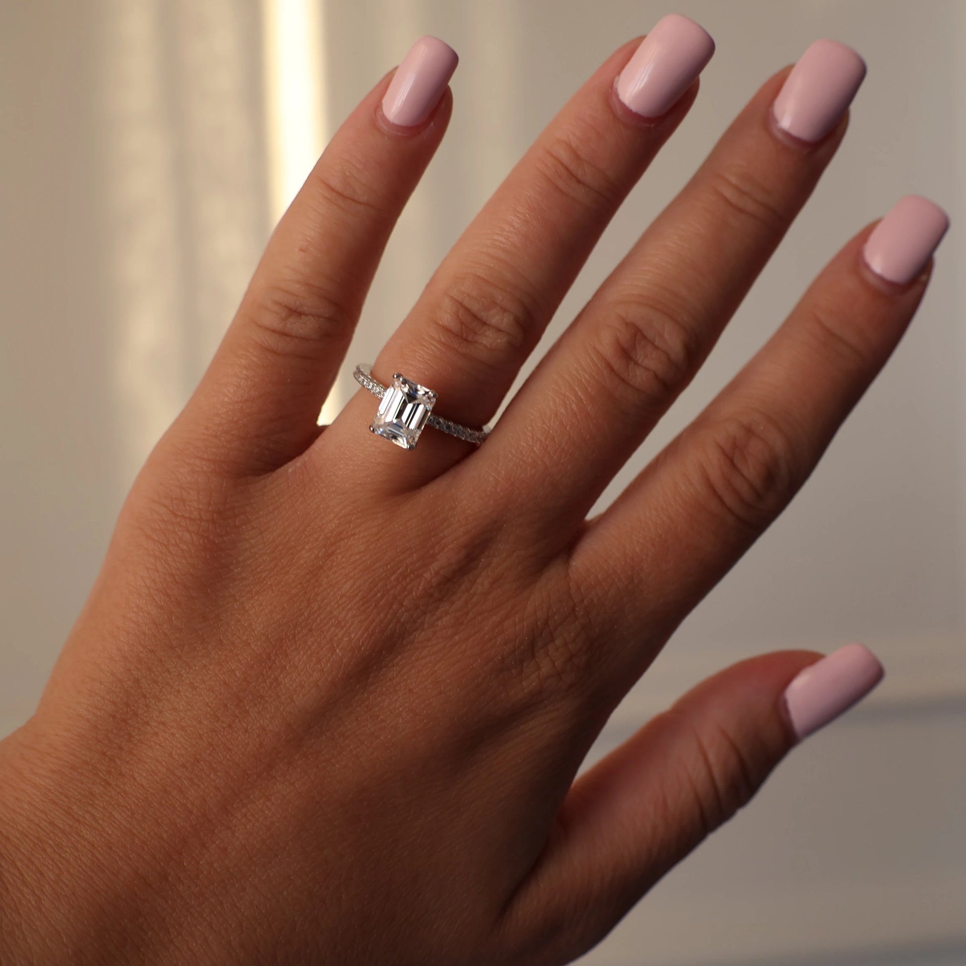 2 carat emerald cut moissanite ring with pave setting