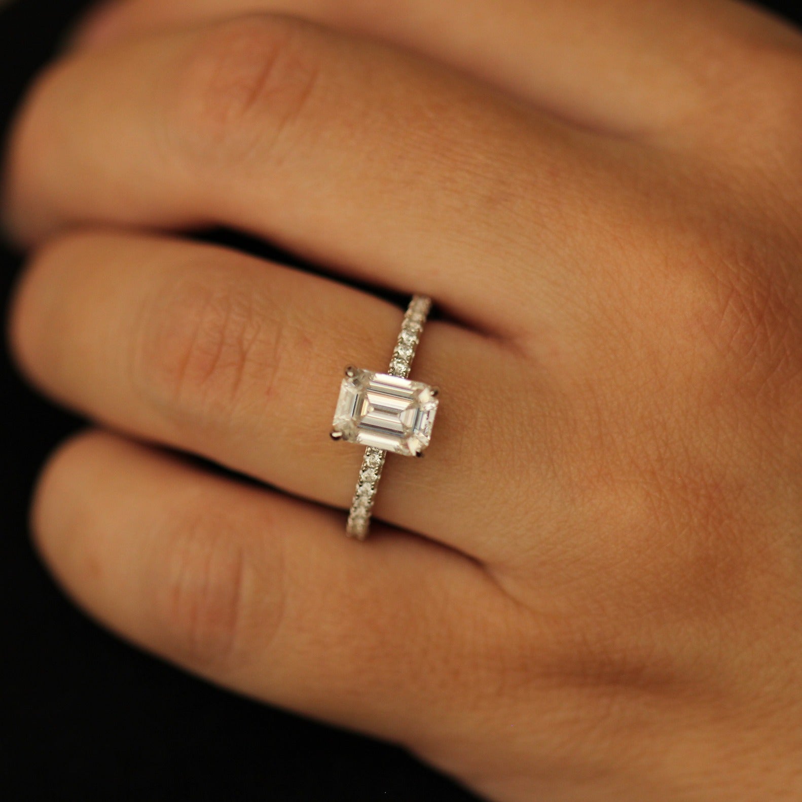 2 carat emerald moissanite ring with a pavé band