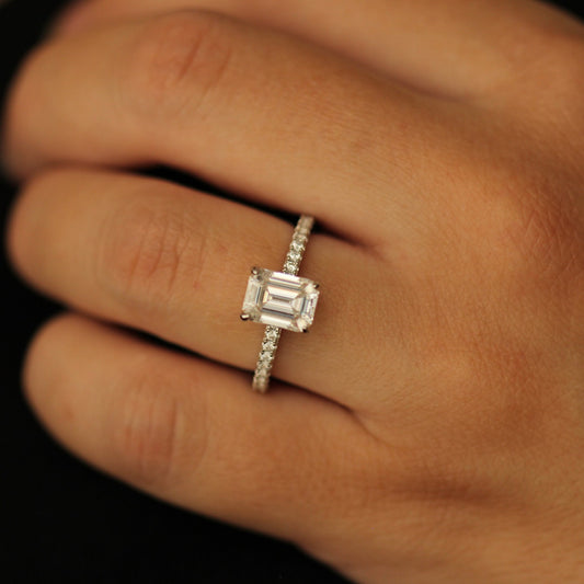 2 carat emerald moissanite ring with a pavé band