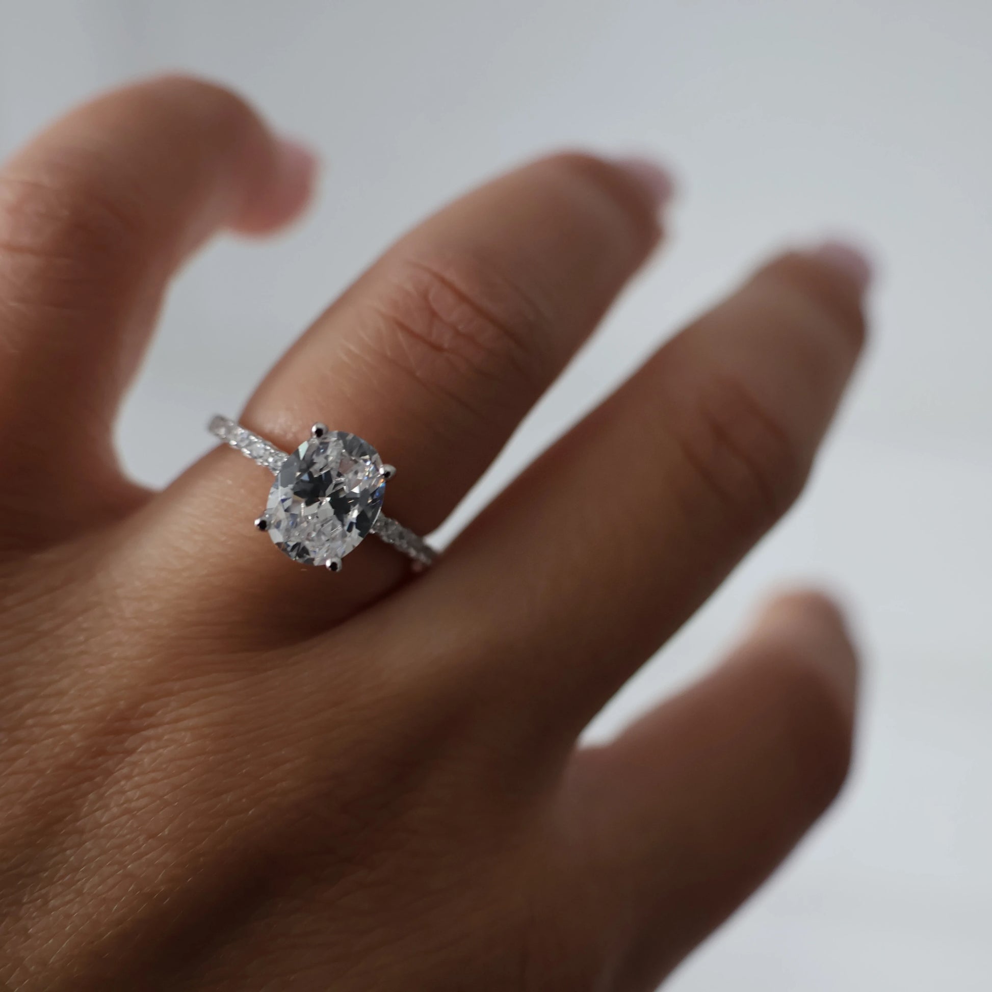 2 carat oval cubic zirconia ring with pavé band in silver