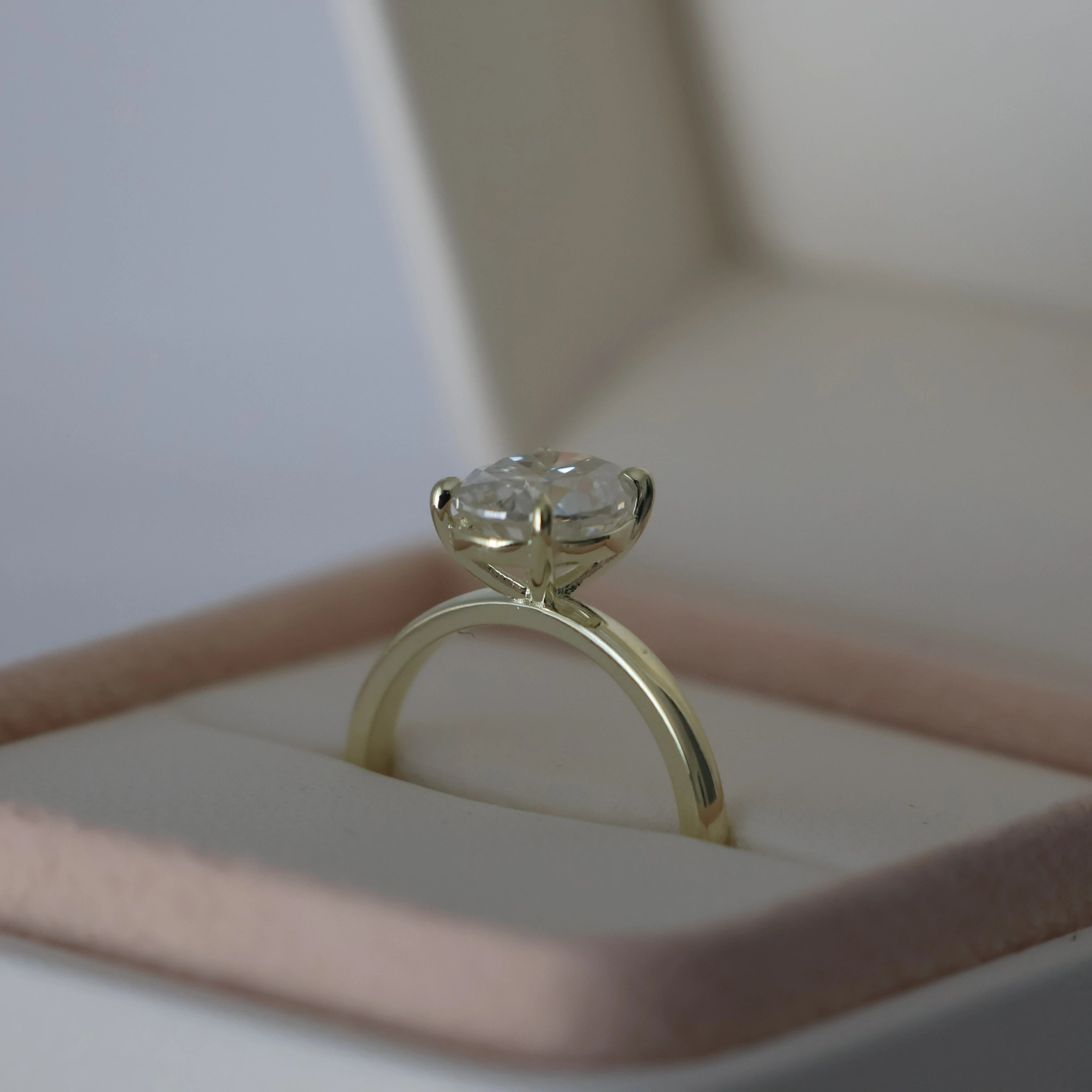 2 ct oval moissanite engagement ring in light 14k gold filled, presented in a proposal box