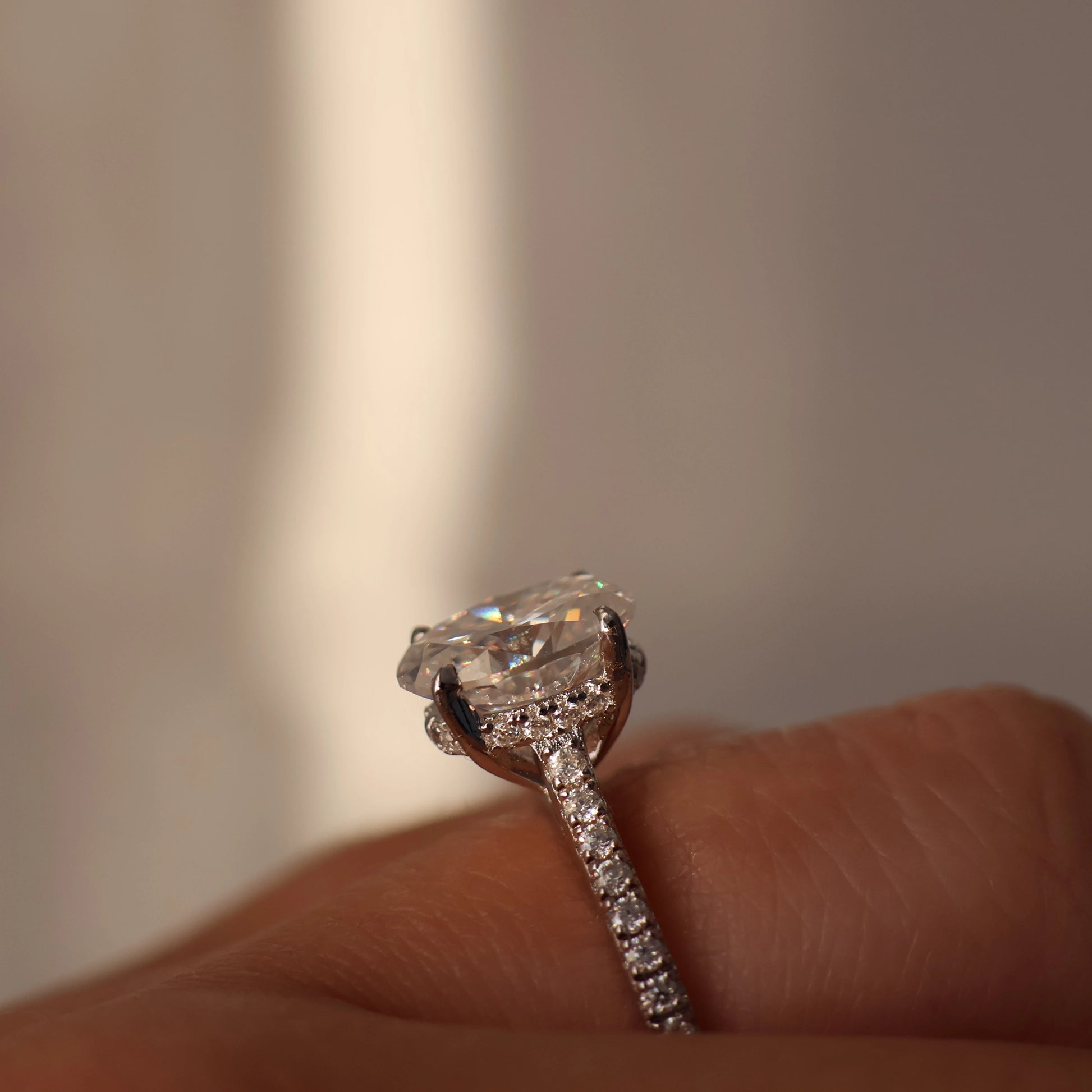 2 carat oval moissanite ring with hidden halo and pave band in silver