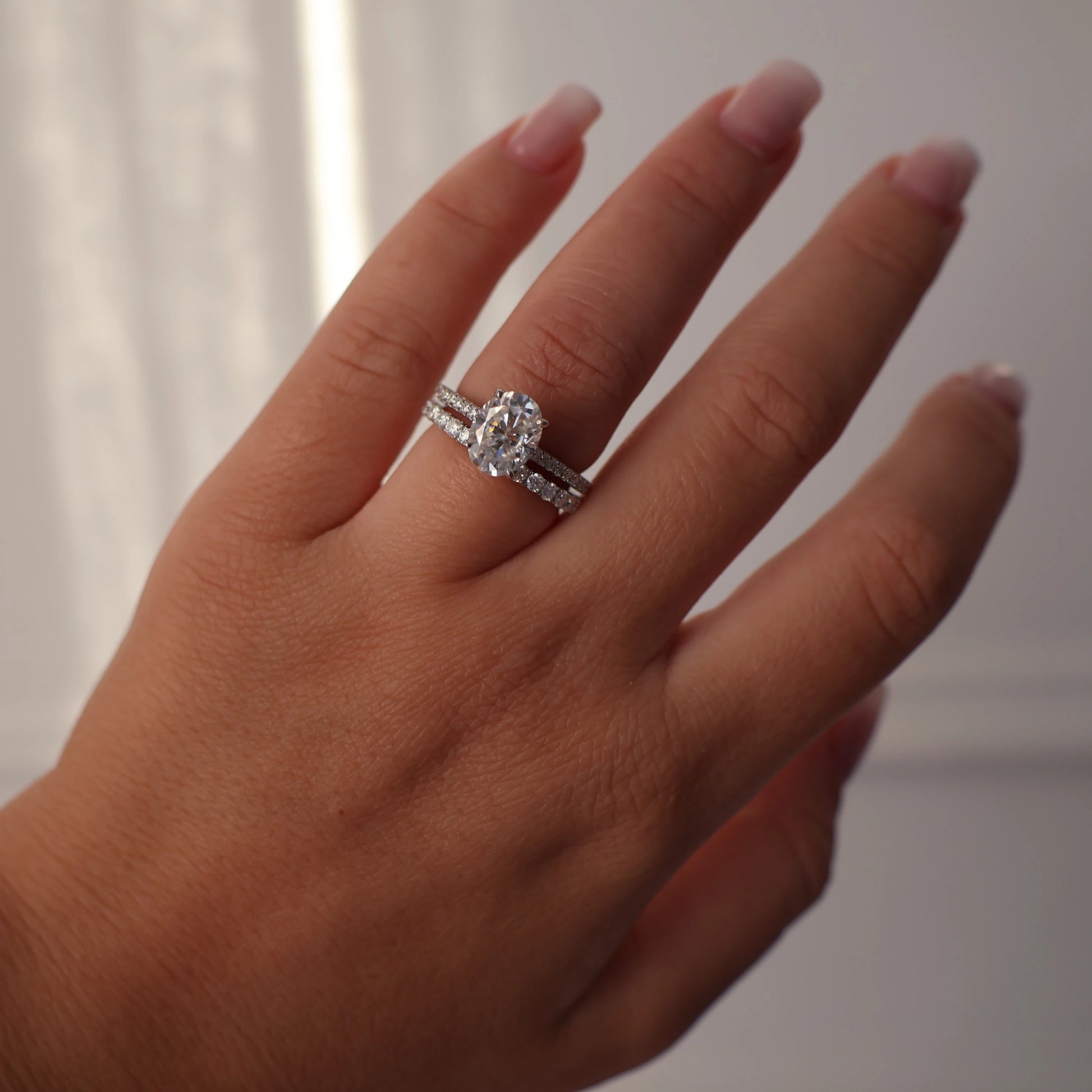 2 carat oval moissanite ring with hidden halo and pave band