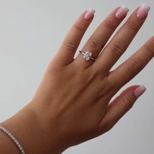 2 carat radiant cut moissanite ring in silver with a hidden halo