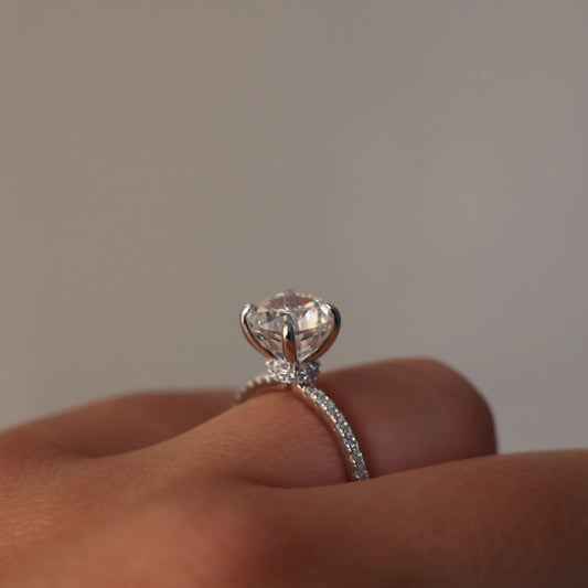 2 carat round cut ring with a silver pavé band and a hidden halo
