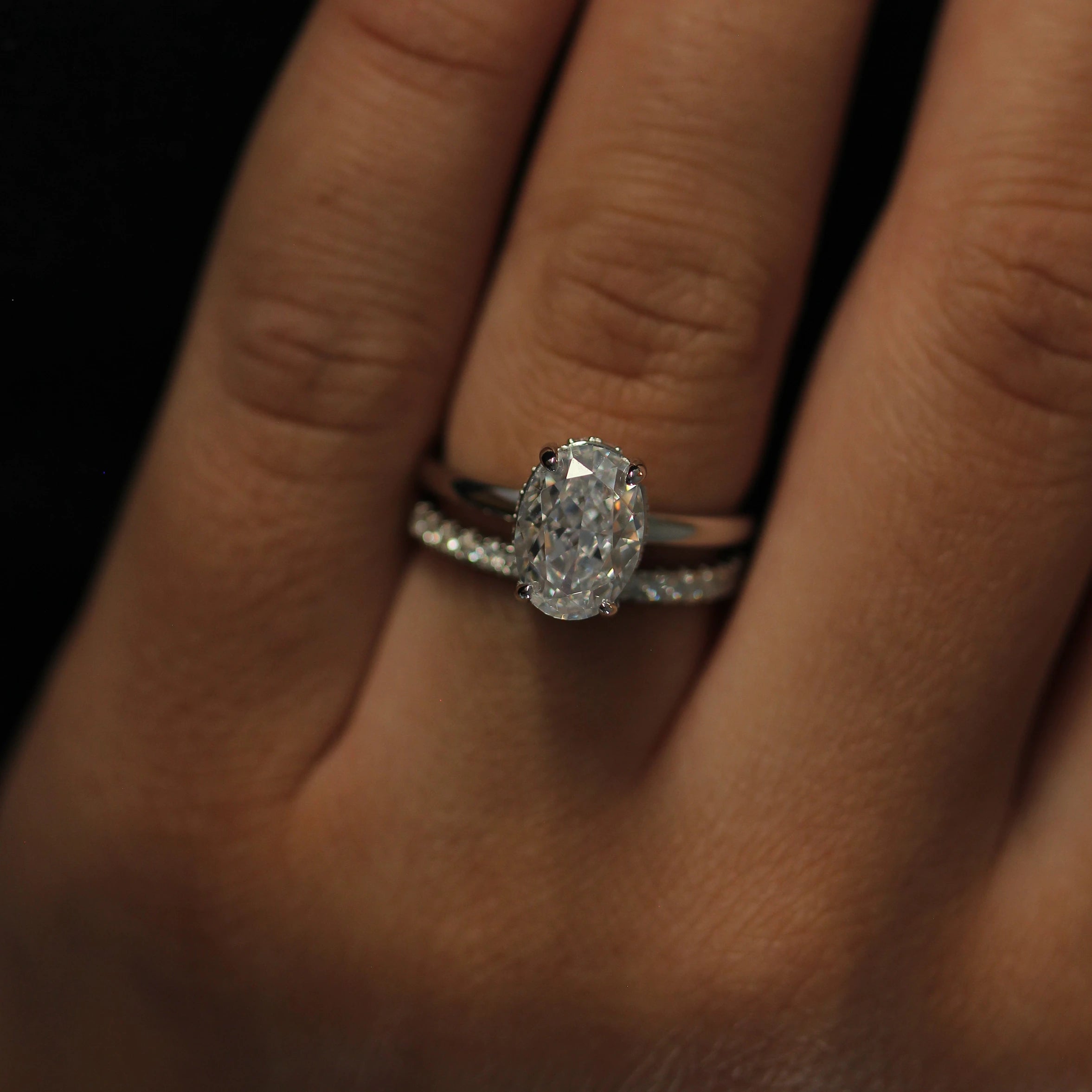 2 carat silver oval ring front view paired with eternity band