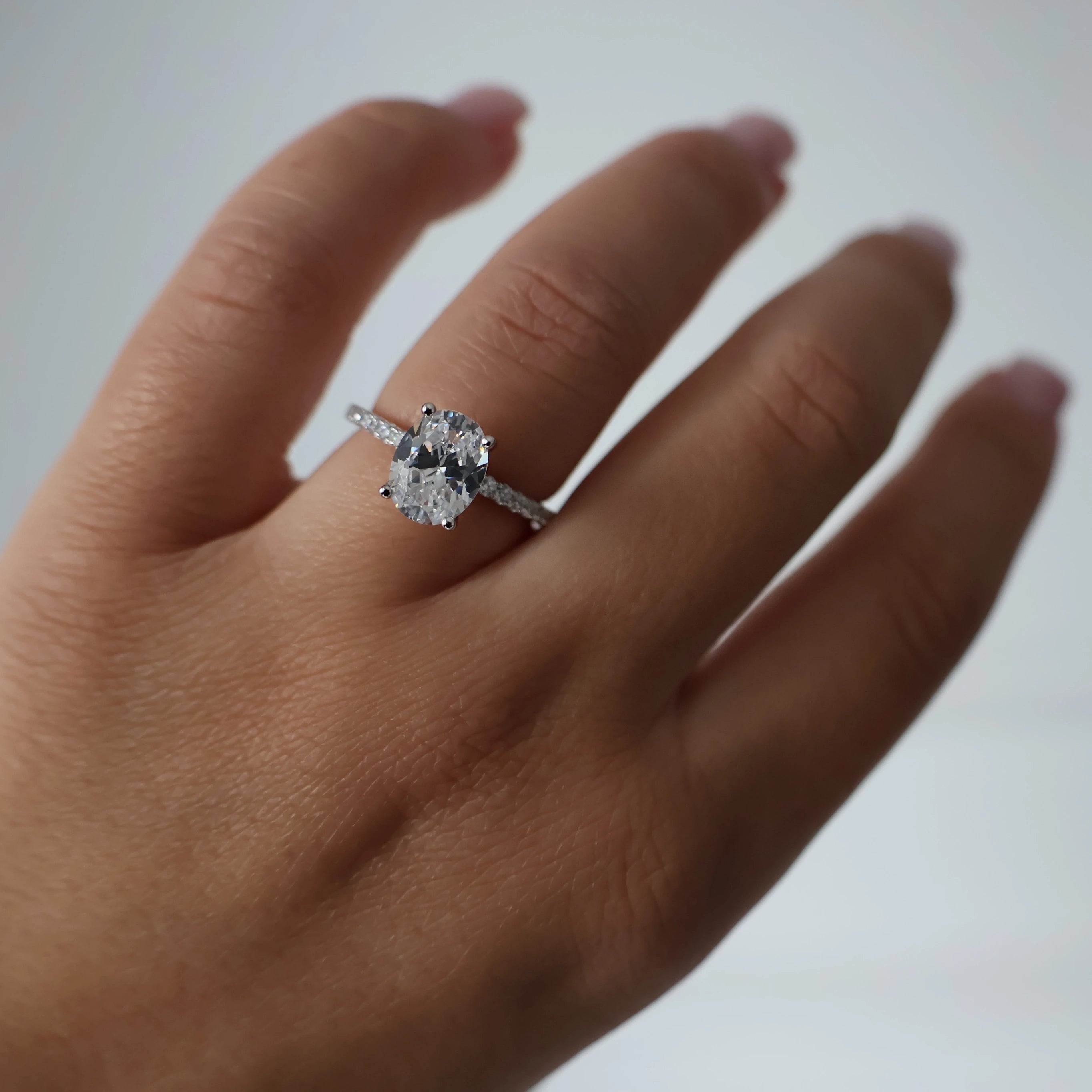 2 carat oval cubic zirconia ring with pavé band in silver