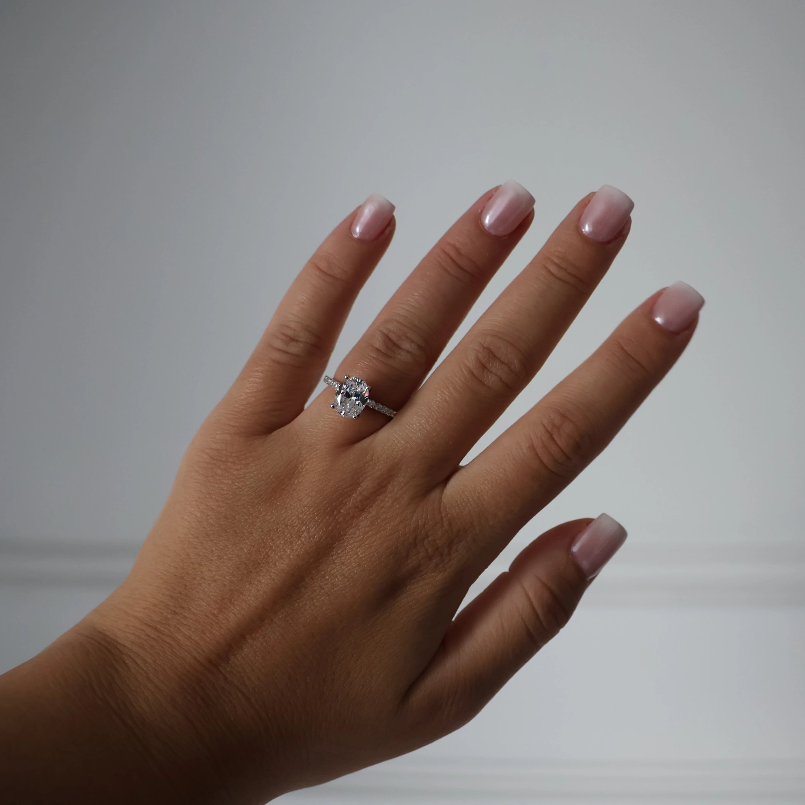 2 carat oval cubic zirconia engagement ring with pavé band in silver