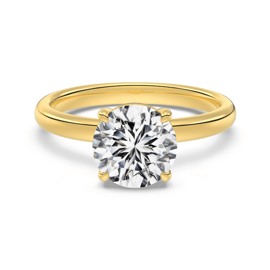 2 ct round gold engagement ring on white background