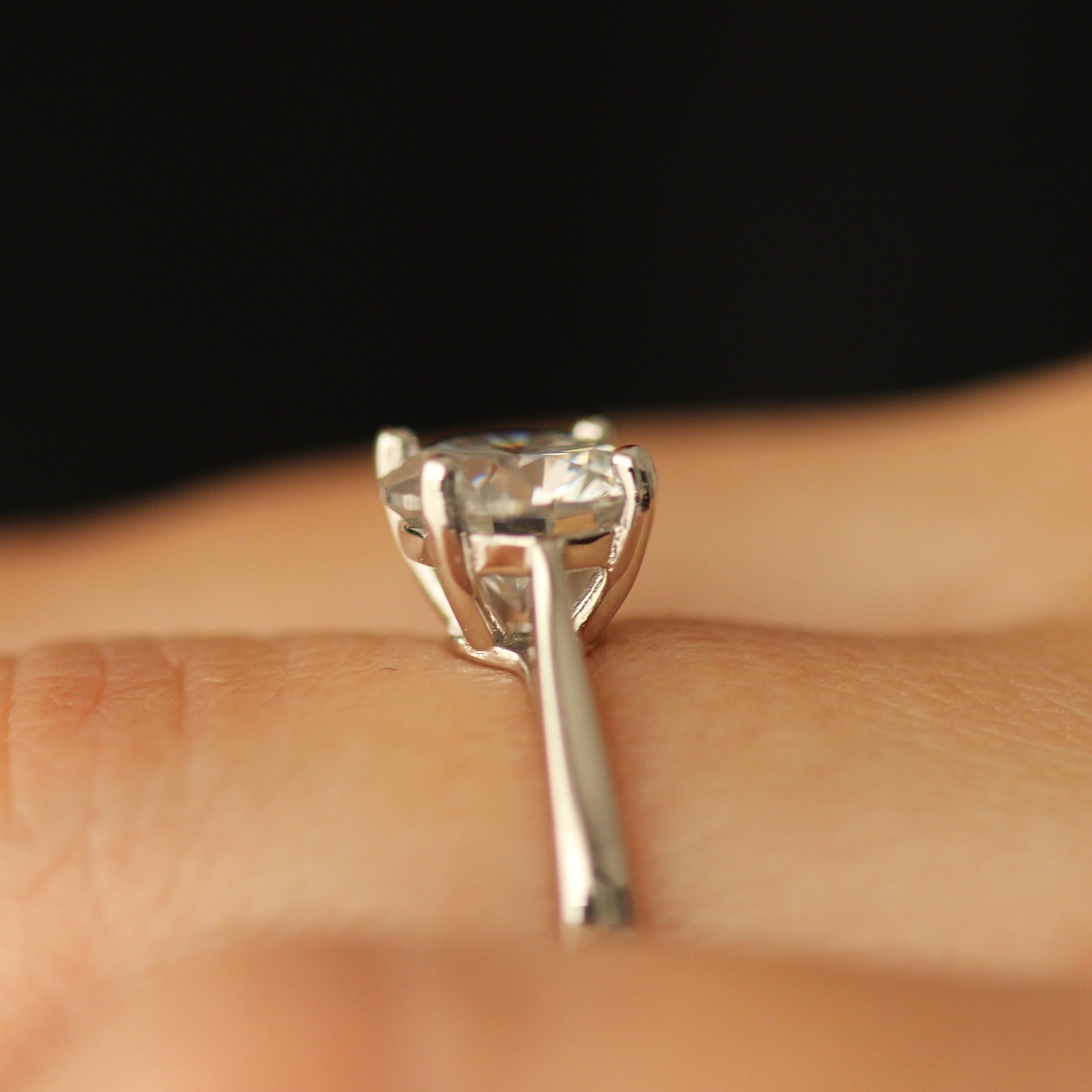 Round cut moissanite ring on hand