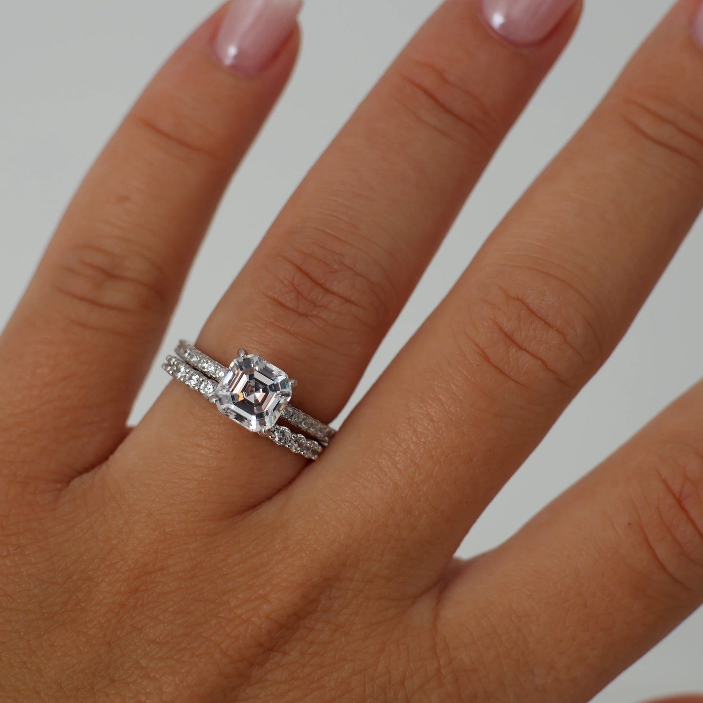 2 ct asscher cut cubic zirconia ring with a pavé band in silver