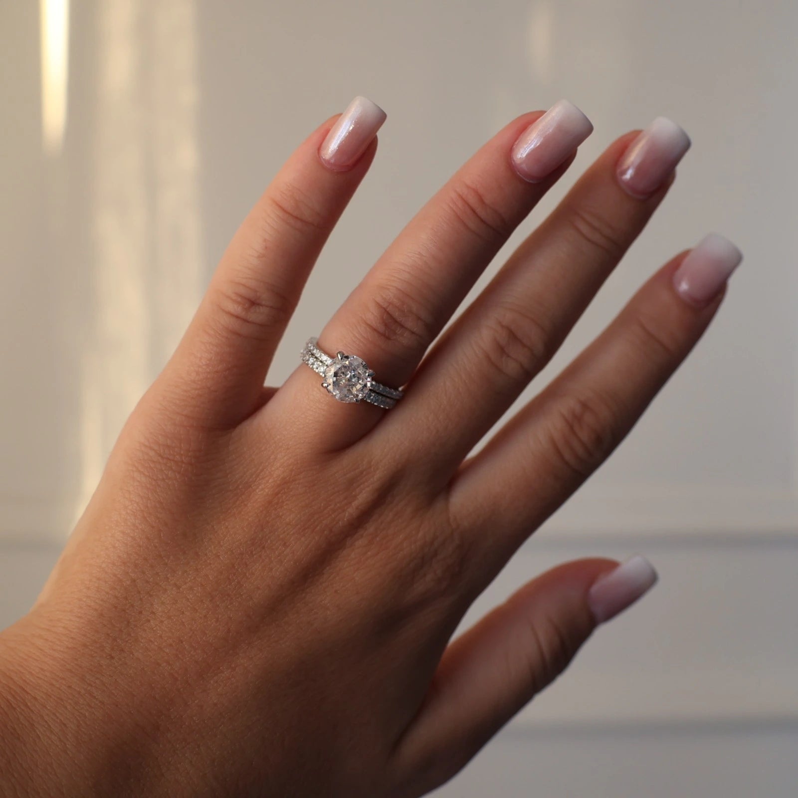 Round 2 carat ring paired with a stacked silver eternity band