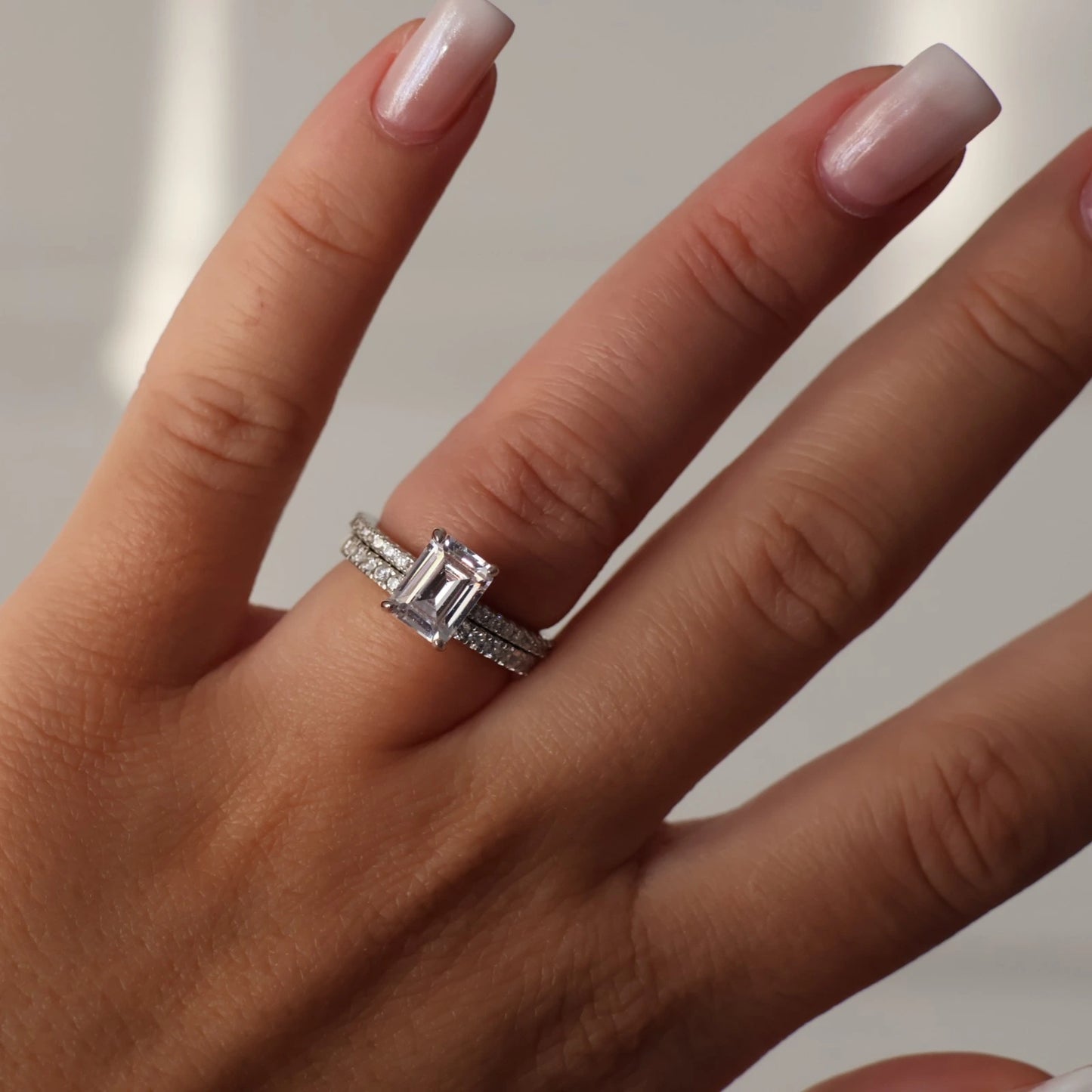 2 carat emerald cut cubic zirconia silver ring stacked with pave band