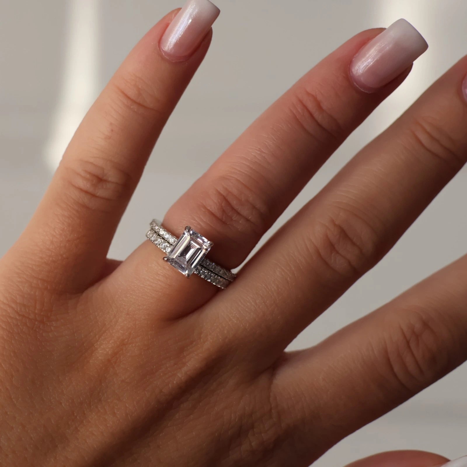 2 carat emerald cut cubic zirconia silver ring stacked with pave band