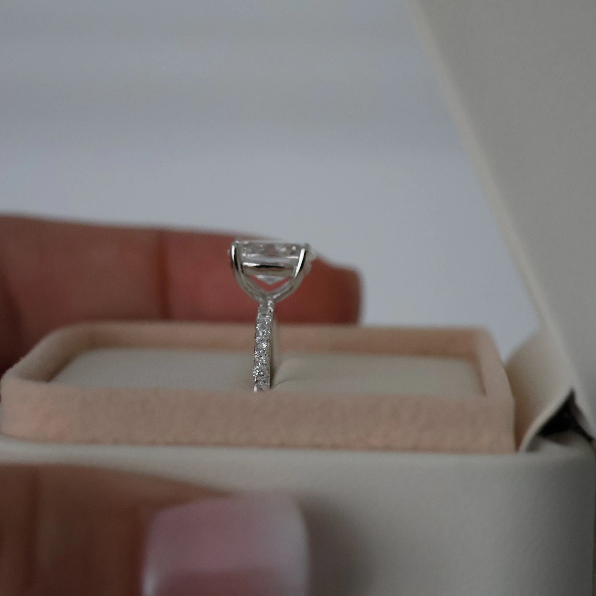 Side view of a 2ct oval pavé ring in silver