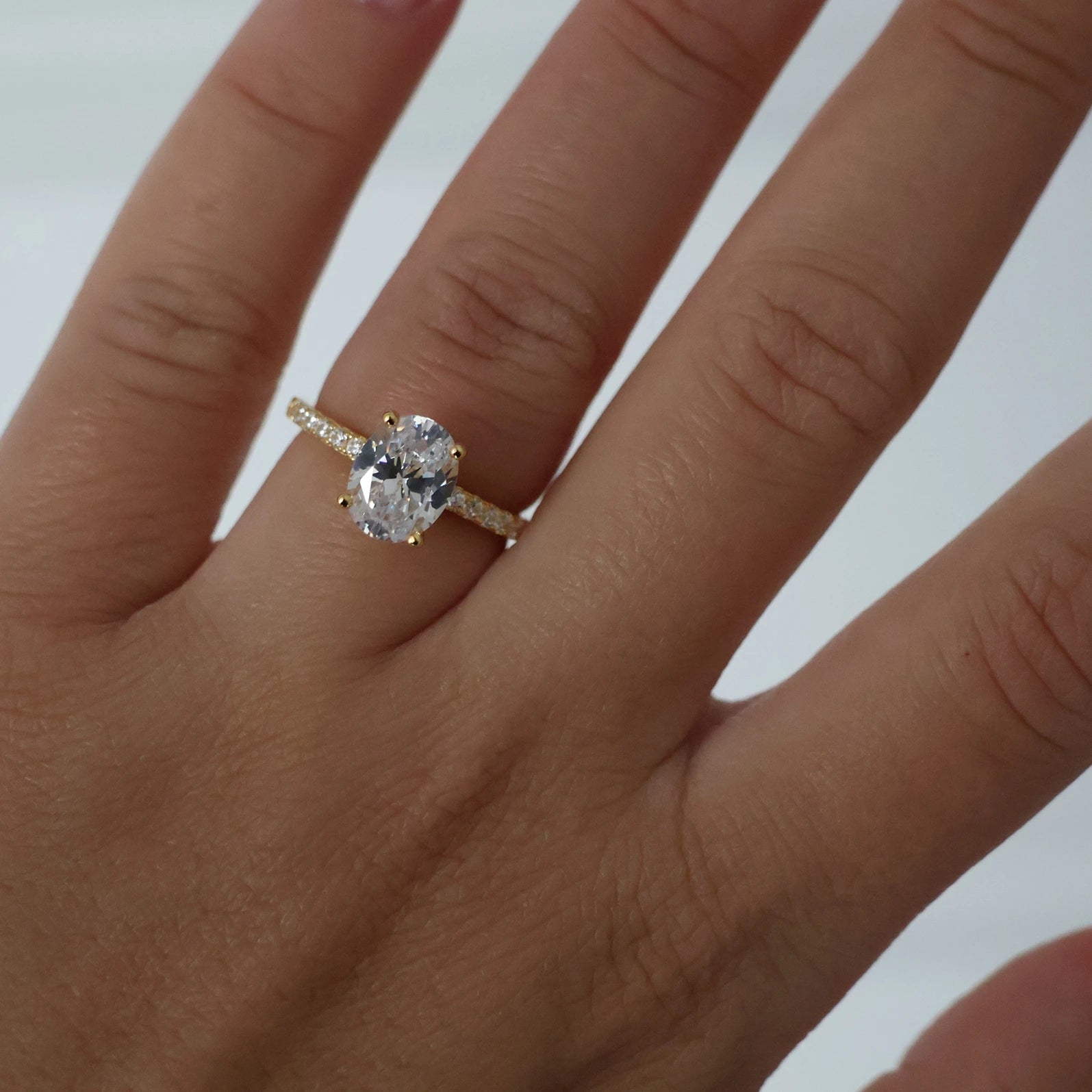 2ct oval ring featuring a pavé band and 18K gold plating