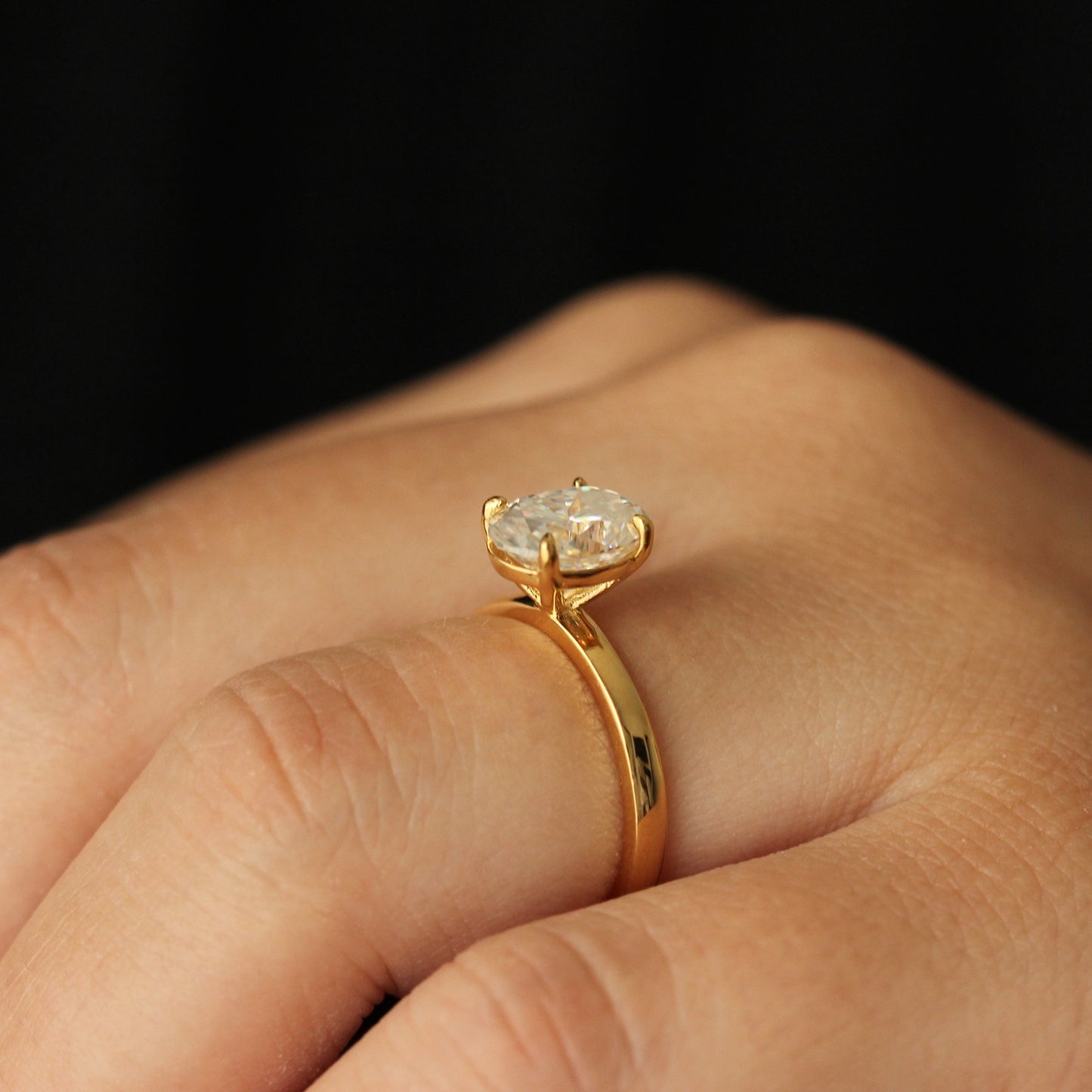 Side view of a 2 carat oval solitaire moissanite ring in 14k gold filled