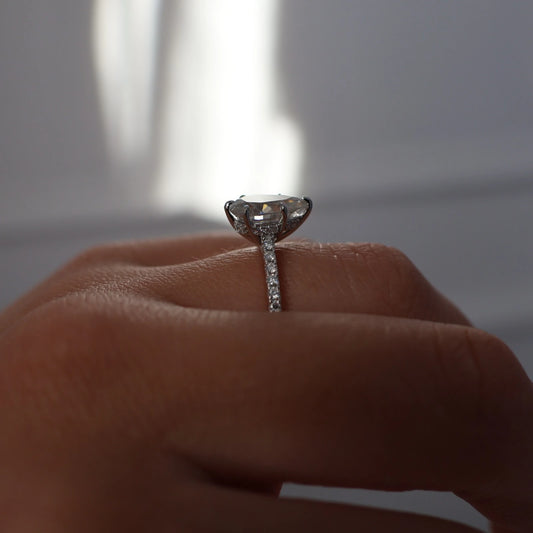 2 carat pear moissanite ring in silver with hidden halo and pavé band